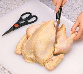 cutting raw chicken