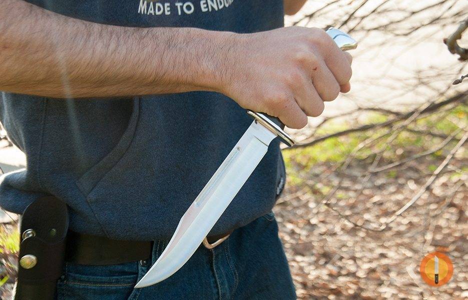 holding a bowie knife